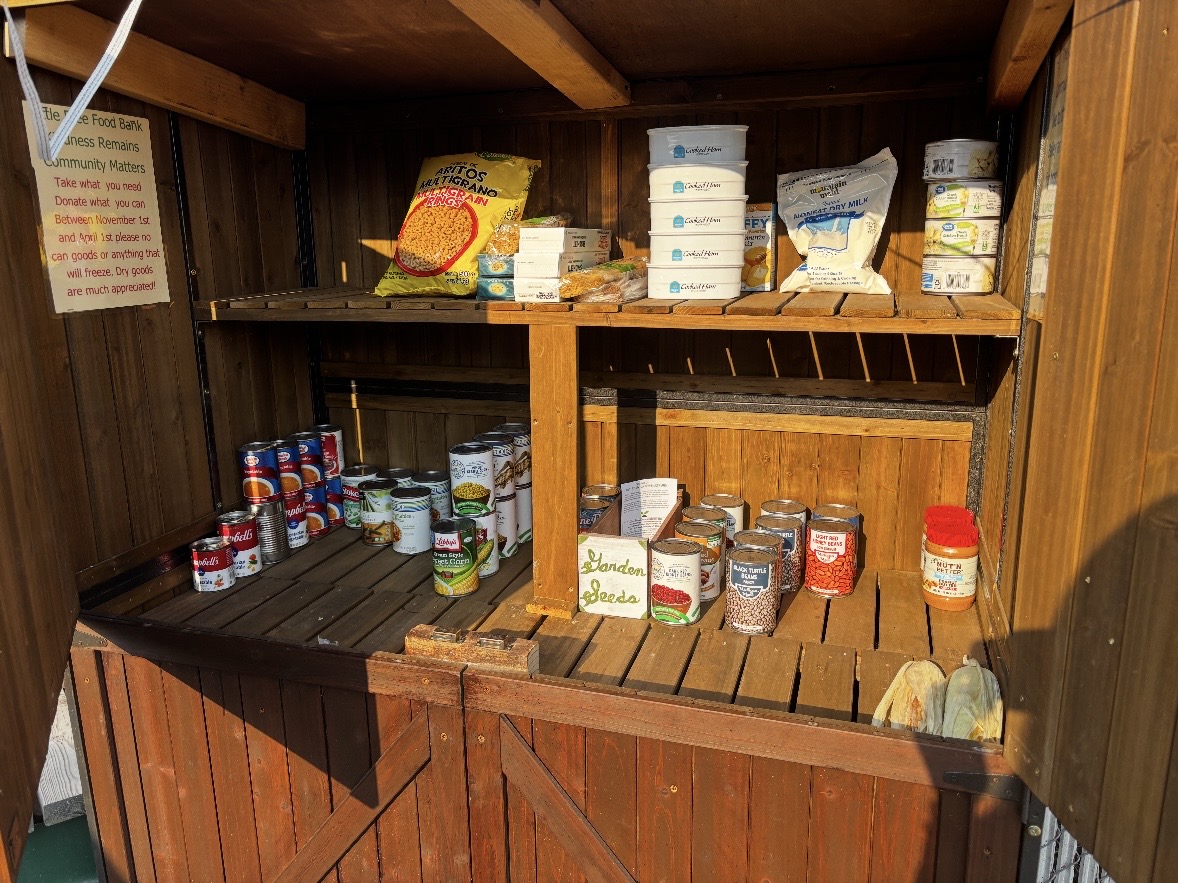 A restocked community food bank cabinet